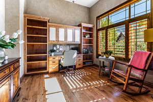 Office space with light wood-style flooring and baseboards
