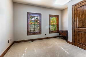 Spare room featuring baseboards and an office area