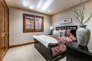 Bedroom featuring a closet, light colored carpet, and recessed lighting