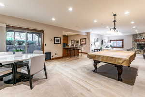 Game room with recessed lighting, pool table, light carpet, and a fireplace