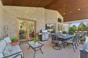 Wooden deck featuring french doors, area for grilling, outdoor dining area, and outdoor lounge area