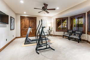 Exercise area featuring light carpet, recessed lighting, and a ceiling fan