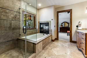 Full bath featuring vanity, a bath, a stall shower, recessed lighting, and light tile patterned flooring