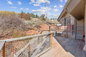 Wooden terrace with view of wooded area