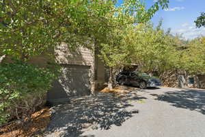 View of property exterior with a garage and driveway