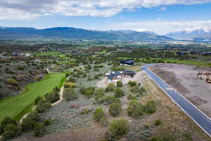Drone / aerial view of mountains and a golf course