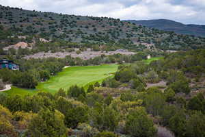 Aerial view of a golf course and mountains