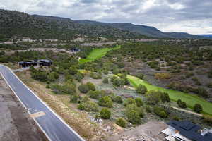 Drone / aerial view of a mountainous background and a golf club