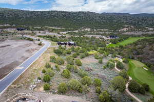 Bird's eye view of a mountain backdrop and a golf course