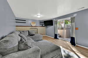 Living room with a textured ceiling and light wood-type flooring