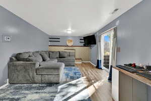 Living area with light wood finished floors and baseboards