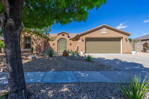 View of front of house with stucco siding, concrete driveway, a garage, and a tile roof