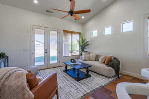 Living room with french doors, recessed lighting, a ceiling fan, and vaulted ceiling