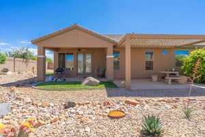 Back of house with a patio area, a ceiling fan, french doors, and stucco siding