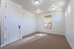 Unfurnished room featuring carpet and baseboards