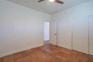 Unfurnished bedroom featuring a closet and ceiling fan