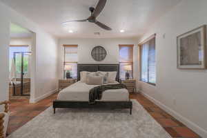 Bedroom featuring a ceiling fan, recessed lighting, and a textured ceiling