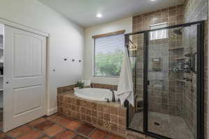 Bathroom with a garden tub, a stall shower, and recessed lighting