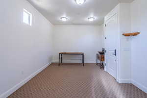Office space with carpet flooring and baseboards