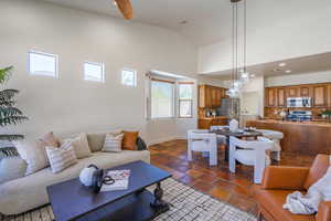 Living area with high vaulted ceiling and recessed lighting