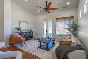 Living room with french doors, recessed lighting, ceiling fan, and high vaulted ceiling