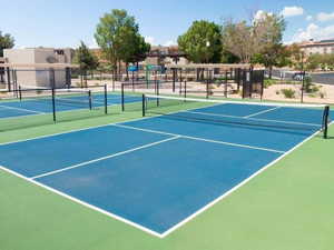 View of tennis court featuring community basketball court
