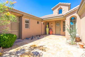Entrance to property featuring stucco siding and a tile roof
