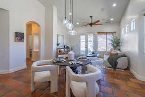 Dining space featuring recessed lighting, arched walkways, a ceiling fan, french doors, and high vaulted ceiling