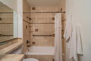 Full bath featuring tiled shower / bath combo and vanity