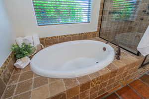 Full bath with a bath and a walk in shower