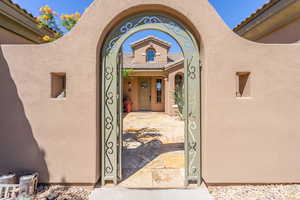 View of exterior entry featuring stucco siding