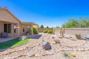 Fenced backyard with a patio