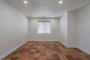 Empty room featuring recessed lighting and a textured ceiling