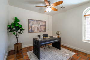 Home office with baseboards and ceiling fan