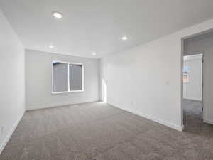 Unfurnished room featuring light colored carpet and recessed lighting