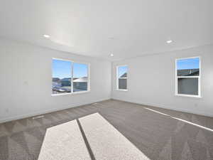 Carpeted spare room featuring recessed lighting