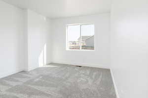 Unfurnished room with carpet floors and baseboards