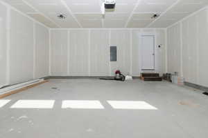 Garage with electric panel and a garage door opener