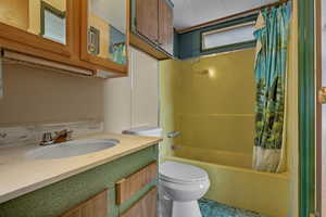 Full bathroom with shower / bath combo with shower curtain and vanity