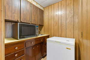 Washroom featuring wood walls and a sink