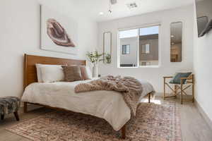 Bedroom featuring light wood-style flooring, recessed lighting, and a ceiling fan