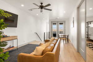 Living room with recessed lighting, light wood finished floors, and ceiling fan