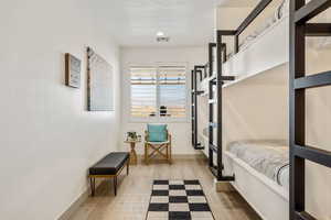 Bedroom featuring light wood-type flooring and baseboards
