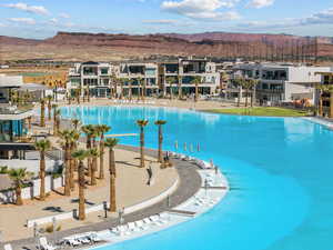 Community pool with a mountain view, a patio, and a residential view