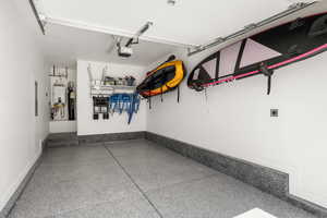 Garage with water heater and a garage door opener
