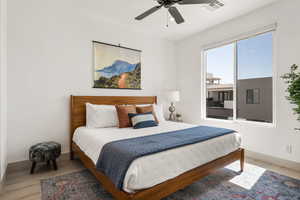 Bedroom with wood finished floors and a ceiling fan