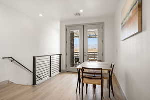 Dining space with light wood-style flooring, french doors, recessed lighting, and a mountain view