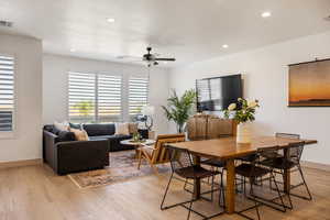 Dining area with light wood finished floors, recessed lighting, and ceiling fan