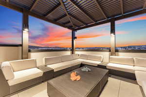 Patio terrace at dusk featuring outdoor lounge area and a patio area