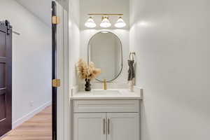 Bathroom featuring vanity and light wood-type flooring